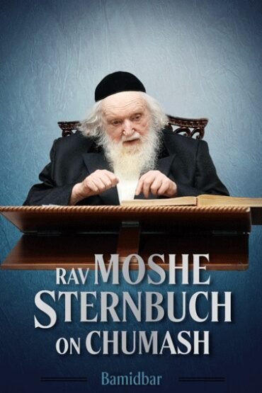 Rav Moshe Sternbuch studying a book on a lectern.